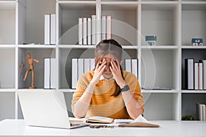 asian woman looks stressed due financial problem bills, calculator, laptop, holds head in hands, feels hopeless. Late