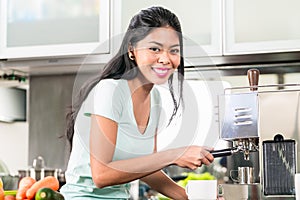Asian woman making espresso in his kitchen