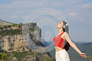 Asian woman meditating listening audio guide outdoor