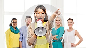 Asian woman with megaphone over group of people