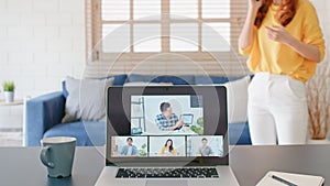 Asian woman on mobile phone call during video call conference, online remote meeting with business coworker at home