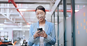 Asian woman, modern office and smartphone for connectivity, social media and digital app. Entrepreneur, employee or