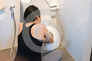 Asian woman with morning sickness,Pregnant female nausea in toilet