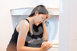 Asian woman with morning sickness,Pregnant female nausea into the toilet bowl