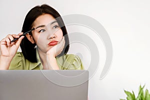 Asian woman office worker sitting at desk with no motivation for work