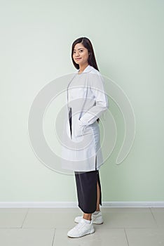 Asian woman ophtalmologist standing at hospital and looking at camera.