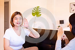 Asian woman patient deaf hearing talking with specialist sign language and showing hands gesture