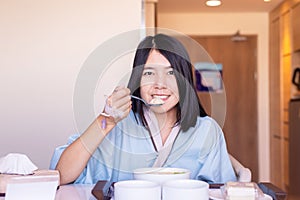 Asian woman patient eating meal on sickbed in the hospital