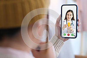 Asian woman patient make video call counseling doctor about healthcare by mobile phone, Telemedicine, Pharmacist