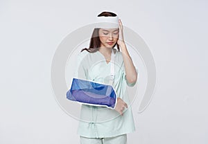 Asian woman patient put on a soft splint due to a broken arm and headache isolated on white background. Insurance and Personal