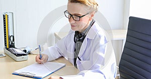 Asian woman patient sitting with doctor about her illness and showing x-ray results with blood pressure and heart rate measurement