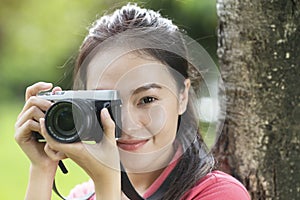 Asian woman photographer take a photo with retro camera