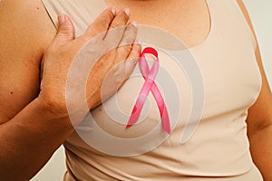 Asian woman with pink ribbon, World Breast Cancer Day at October