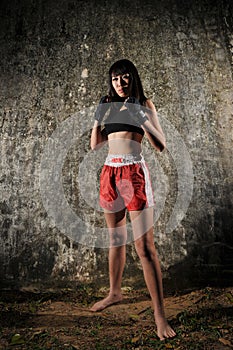 Asian Woman Practising Muay Thai Boxing