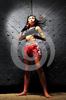 Asian Woman Practising Muay Thai Boxing