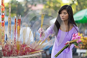 Asian woman praying at temple