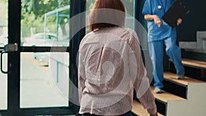 Asian woman preparing to attend checkup visit with nurse