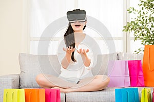 Asian woman presenting shopping online with VR headset