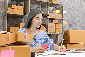 Asian woman with product packaging box.