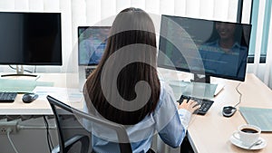 Asian woman programmer typing source code with computer pc for Developing program or application in her office