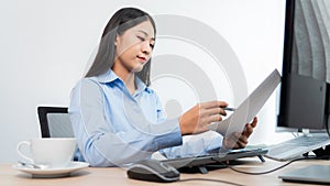 Asian woman programmer typing source code with computer pc for Developing program or application in her office