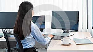 Asian woman Programming working with computer and typing data code to developing program at table In Office, technology concept