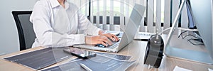 Asian woman Programming working with computer and typing data code to developing program at table In Office, technology concept