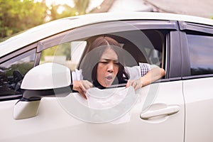 Asian woman puke or vomiting into plastic bag in car,Car Sick and motion sickness photo