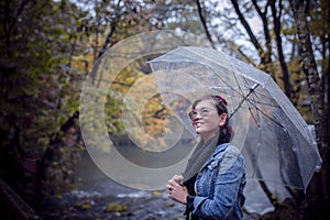 Asian woman with rain umbrella toothy smiling with happiness sta