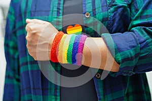 Asian woman with rainbow flag, LGBT symbol rights and gender equality, LGBT Pride Month in June