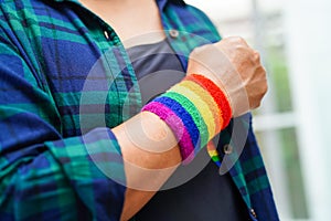 Asian woman with rainbow flag, LGBT symbol rights and gender equality, LGBT Pride Month in June