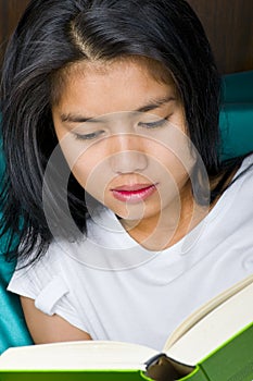 Asian woman reading a book