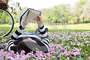 Asian woman reading booklet