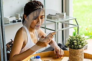 Asian woman reading message form mobile phone
