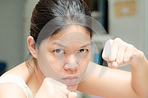 Asian woman ready to fight guarding with empty hand