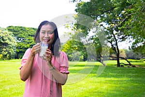 Asian woman relax time in park.