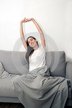 Asian woman relaxed and resting breathing fresh on sofa.