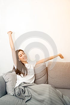 Asian woman relaxed and resting breathing fresh on sofa.