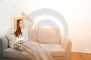 Asian woman relaxed and resting breathing fresh on sofa at home.