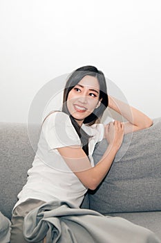 Asian woman relaxed and resting breathing fresh on sofa.