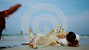 Asian woman relaxing with dog on the beach. Recreation and lifestyle on summer holiday