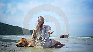 Asian woman relaxing with dog on the beach. Recreation and lifestyle on summer holiday