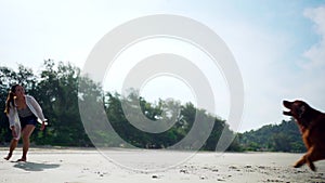 Asian woman relaxing with dog on the beach. Recreation and lifestyle on summer holiday