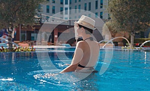 asian woman relaxing in swimming pool spa