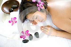 Asian woman restful on massage therapy bed