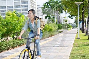 Asian woman riding a bicycle in the park