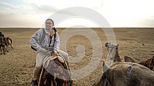 Asian woman riding camel  at Giza pyramid Egypt scary activity and exciting for tourist