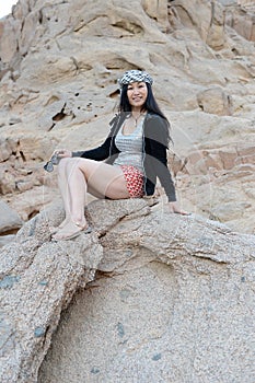 Asian woman on rocks