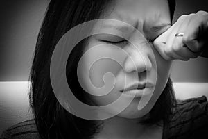 Asian woman rubbing her eye. Black and white tone. Concept of  eye`s problem, dust allergy, dry eye, watery, itching or contact