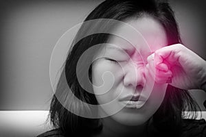 Asian woman rubbing her eye. Black and white tone and red spot on her eyes. Concept of  eye`s problem, dust allergy, dry eye,